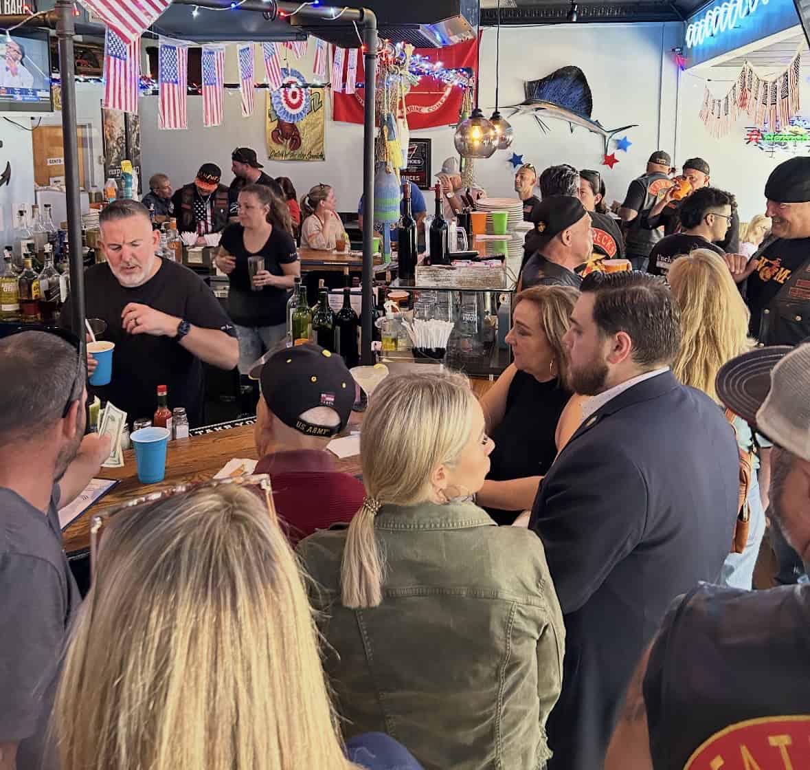 Vibrant scene at Uncle Vinnie's Clam Bar with customers enjoying fresh seafood and lively atmosphere.